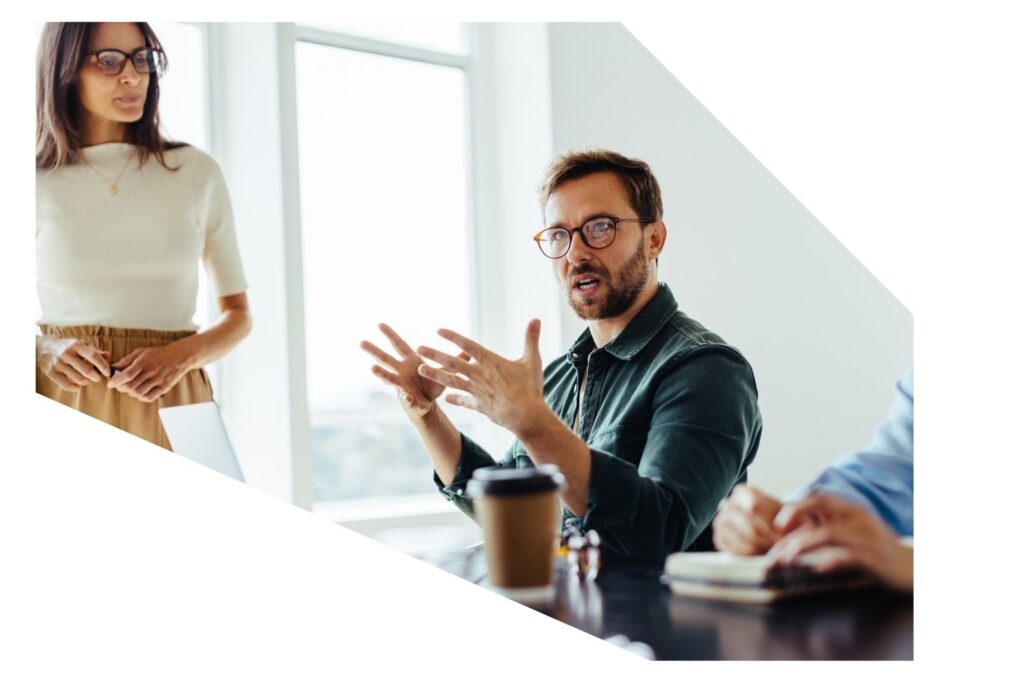 Man in the office discussing Investment, Wealth Protection and Superannuation with his team