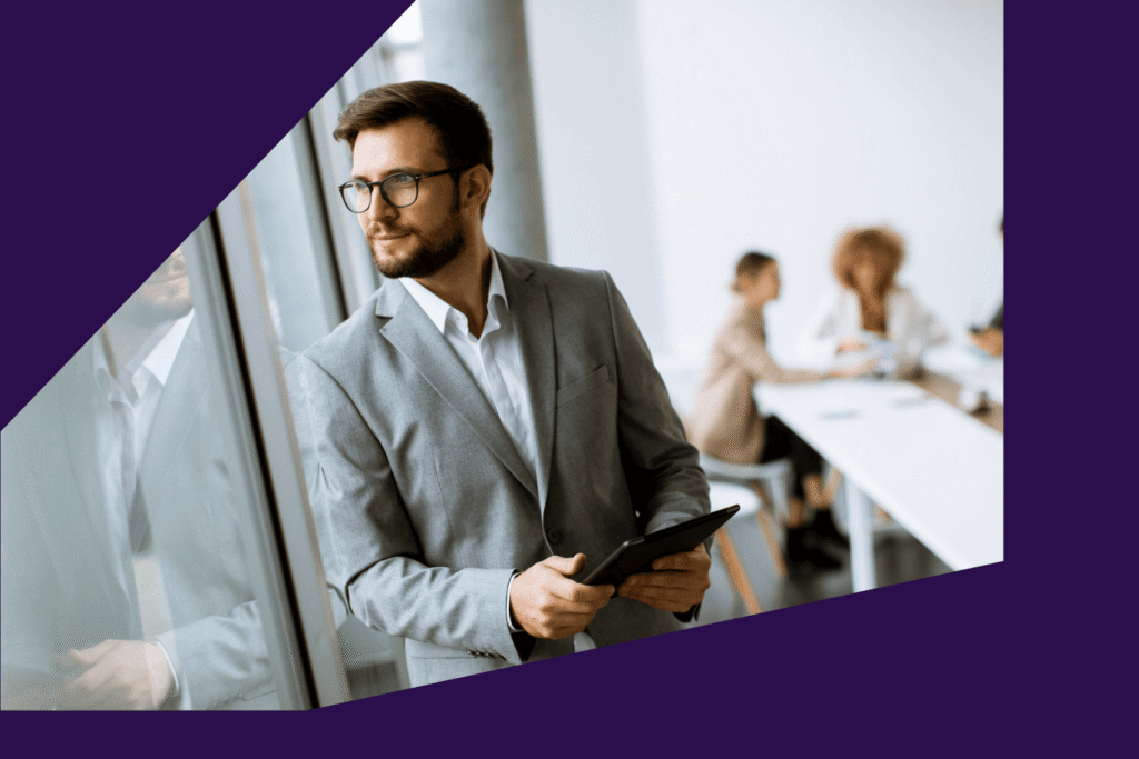 Business man looking out window SLS Advisory