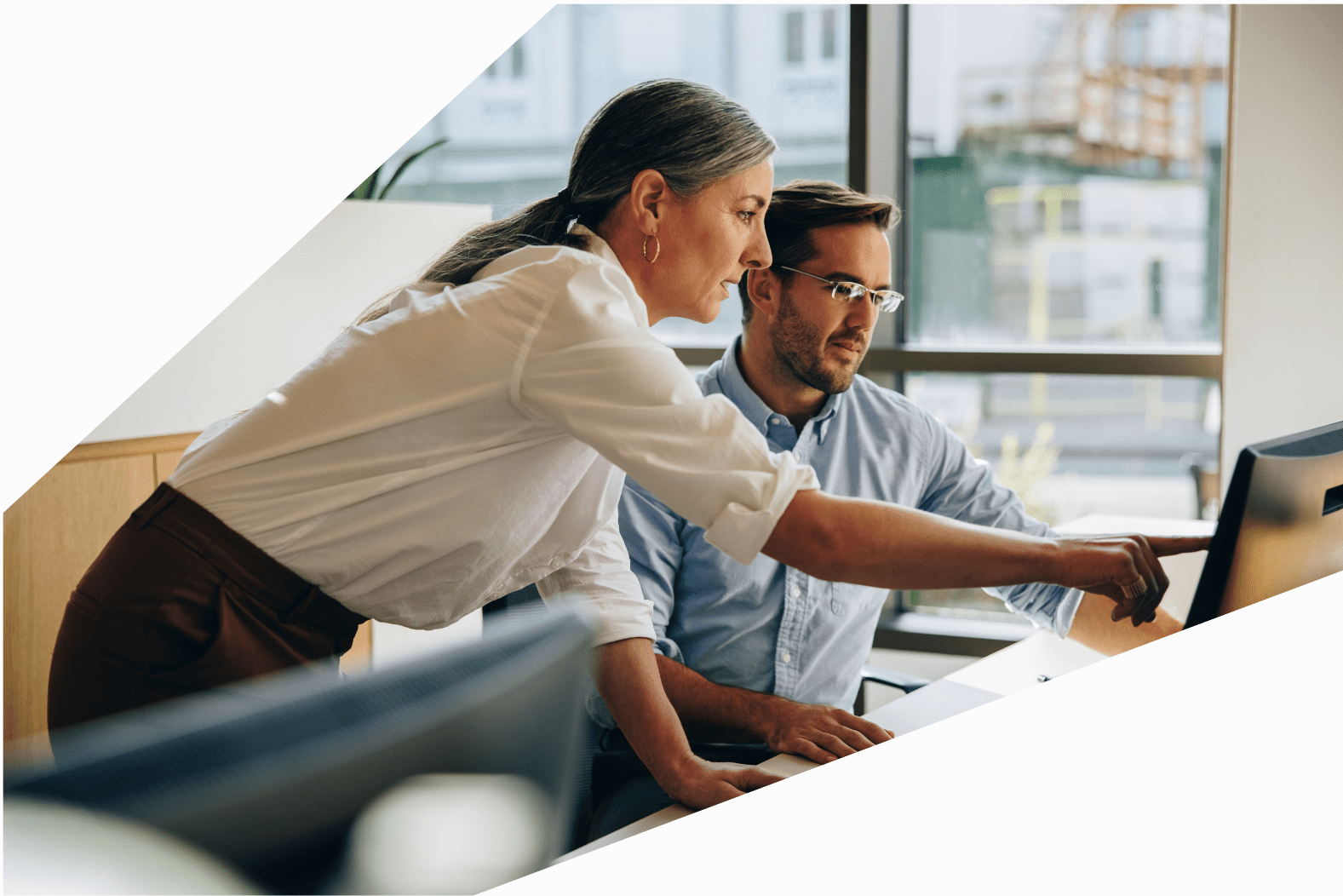 Woman and man working in the office SLS Advisory